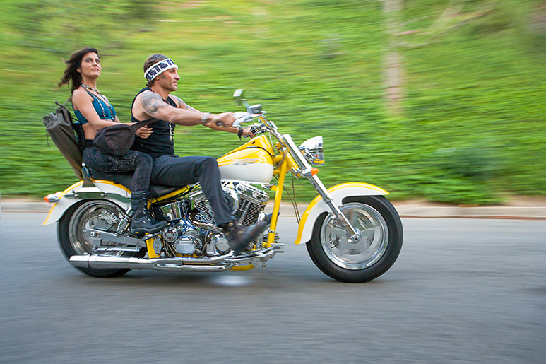Rina Jakubowicz and Eric Paskel on a motorcycle Celebrity Yoga Instructors