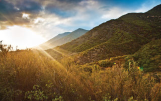 Sunbeams shine over the mountain side horizon. The Power of Space in Healing, Yoga Therapy, LA YOGA Magazine, March 2016