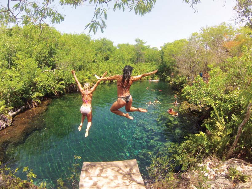 Elise Joan and retreat goer leaping into the water 