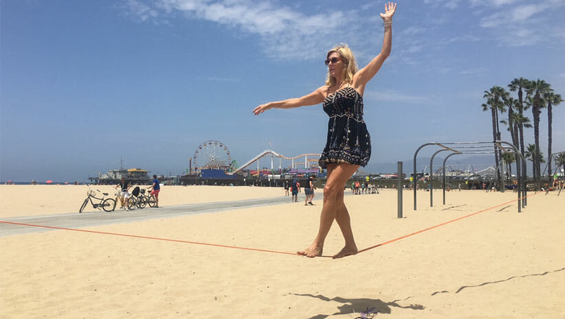 Karen Henry slacklining on Santa Monica Beach 
