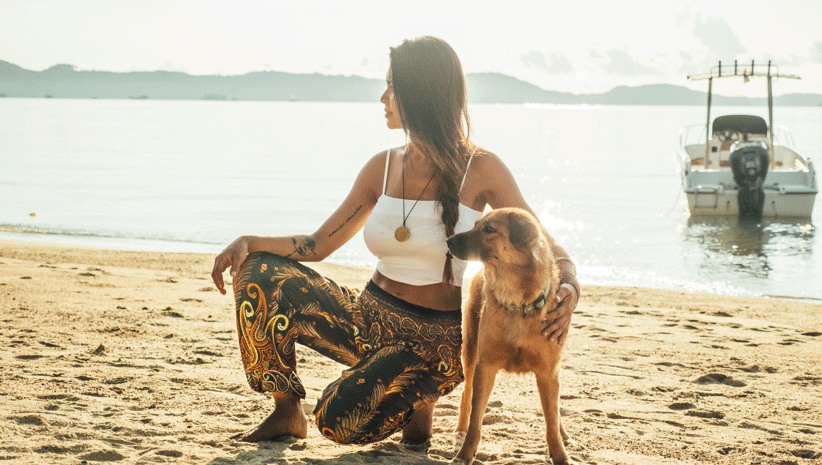 Woman Wearing Bohemian Island Pants with Dog in Thailand