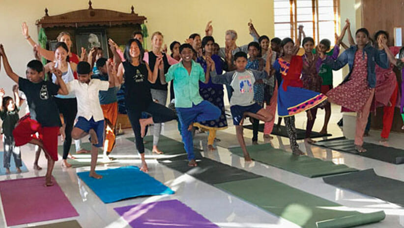Yoga Gives Back Group Doing Yoga 