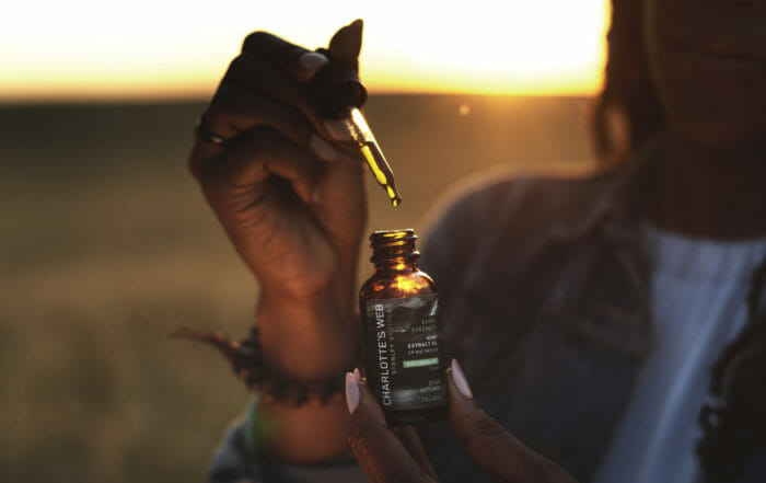 woman with CBD dropper