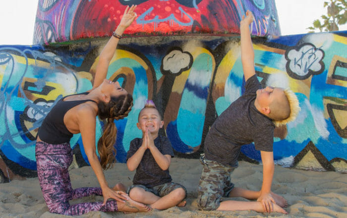 Desi Bartlett and kids practicing family yoga