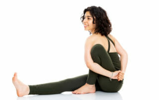 Natalie Asatryan in a Yoga pose shares stress reduction practices
