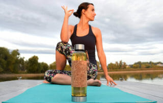 Woman practicing yoga with tea