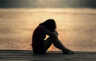 Woman practicing yoga for grief relief