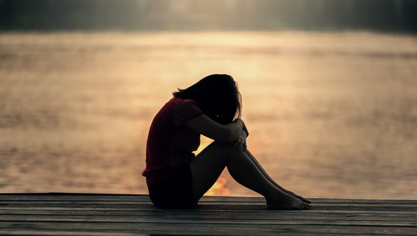 Woman practicing yoga for grief relief