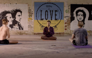 Scene of people meditating in the film Chasing the Present