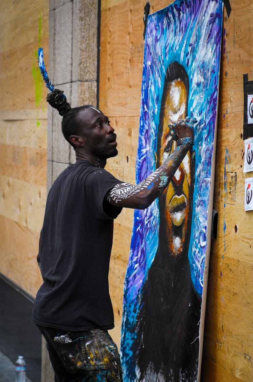 Artist paints George Floyd on Vine Street at Hollywood Blvd.