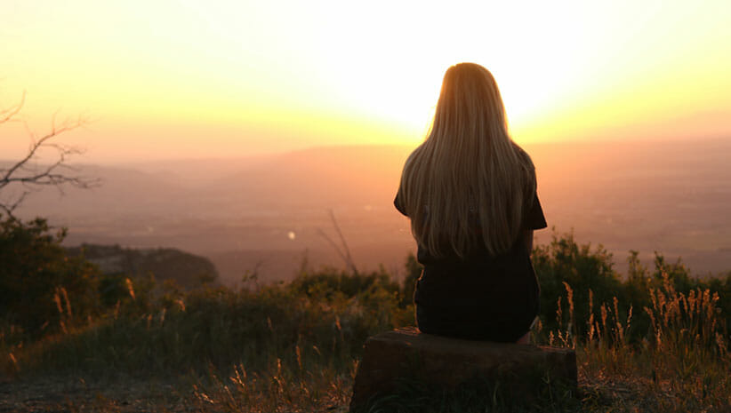 person sitting at sunset understanding meditation