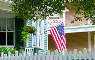 Celebrate freedom with a flag flying at a house