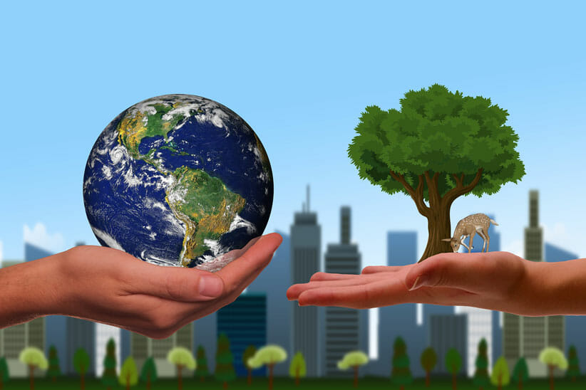 hand holding earth to co-create our world