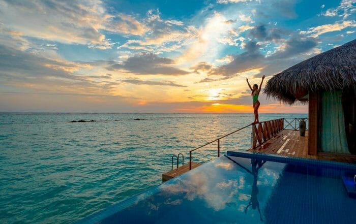 woman in yoga pose in the Maldives showcasing wellness travel