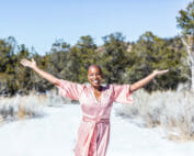 Tracee Stanley Author of Radiant Rest with her hands in the air