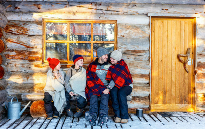 family outside a cabin demonstrating how to declutter your holidays