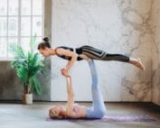 two women practicing yoga