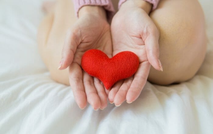 hands holding a heart to demonstrate healing in the world