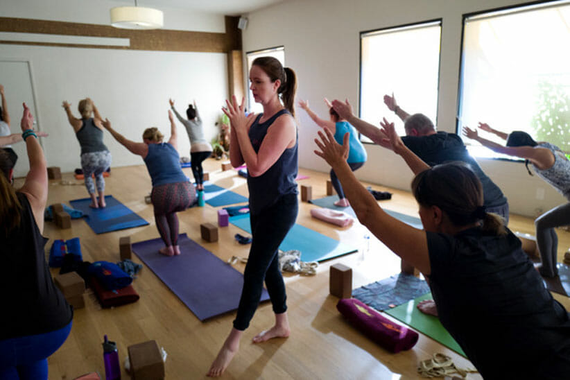 Claire Hartley in a group of people during yoga teacher training