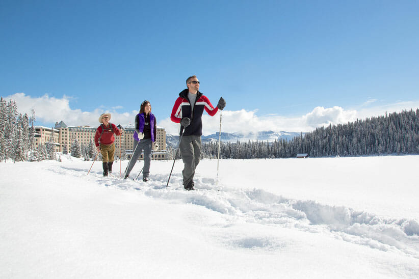 three people cross country skiing in a snowy landscape