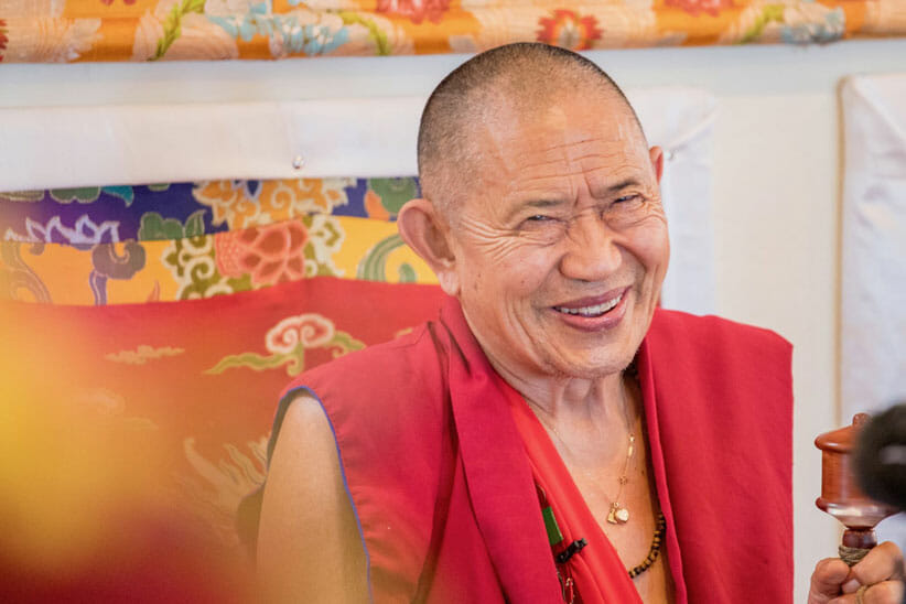 Garchen Rinpoche smiling in red monk robes