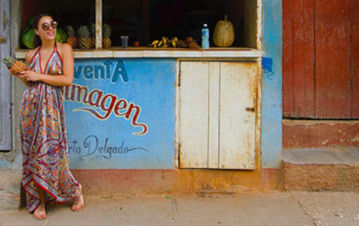 Woman in front of a cafe for Luxury Travel Hackers