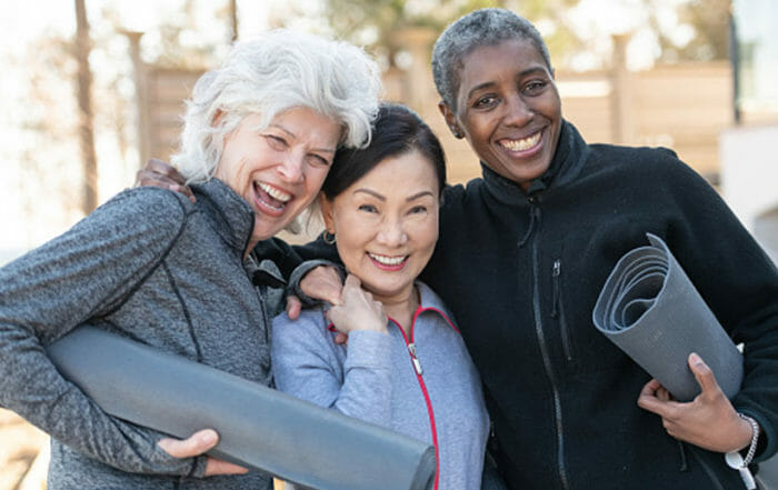 three people with white hair holding yoga mats demonstrating Shanti Malibu concept