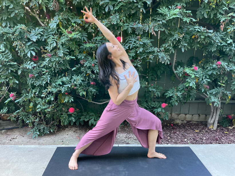 reverse warrior yoga pose with hand on heart