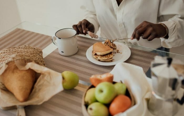 person at a table with food practicing mindful eating