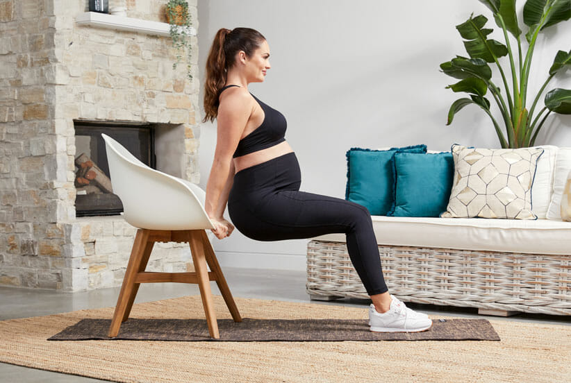 Emily Skye doing chair dip working out during pregnancy