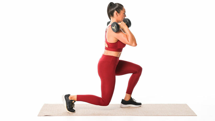 woman demonstrating lunges with weights wearing red yoga clothing