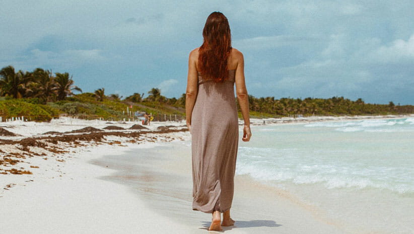 woman walking by the ocean 