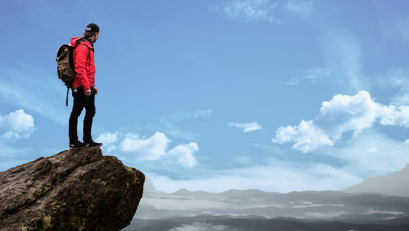 person at top of mountain to connect to soul's purpose