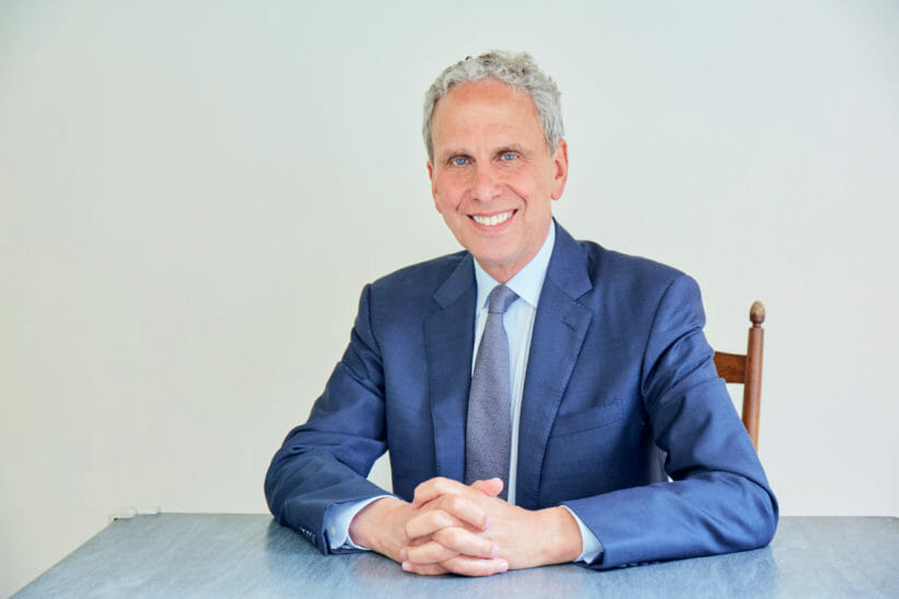 Meditation Teacher and David Lynch Foundation President Bob Roth wearing blue suit and smiling at camera