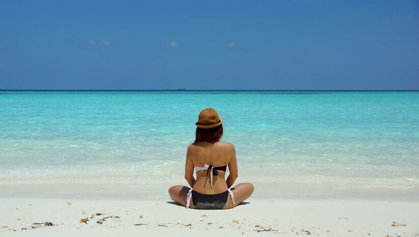 woman in meditation practice looking at ocean