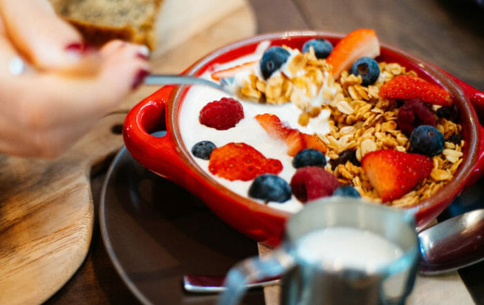 person with parfait for breakfast for a strong breakfast