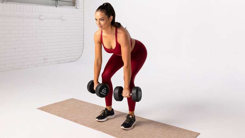Emily Skye performs dumbbell deadlifts, a compound movement recommended for women going through menopause.