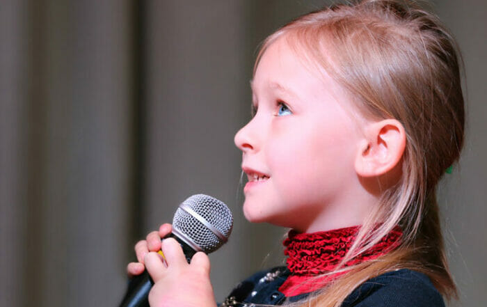 girl with blond hair with microphone