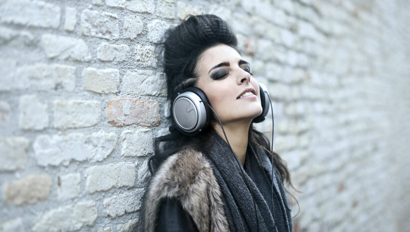 Woman with black hair with headphones