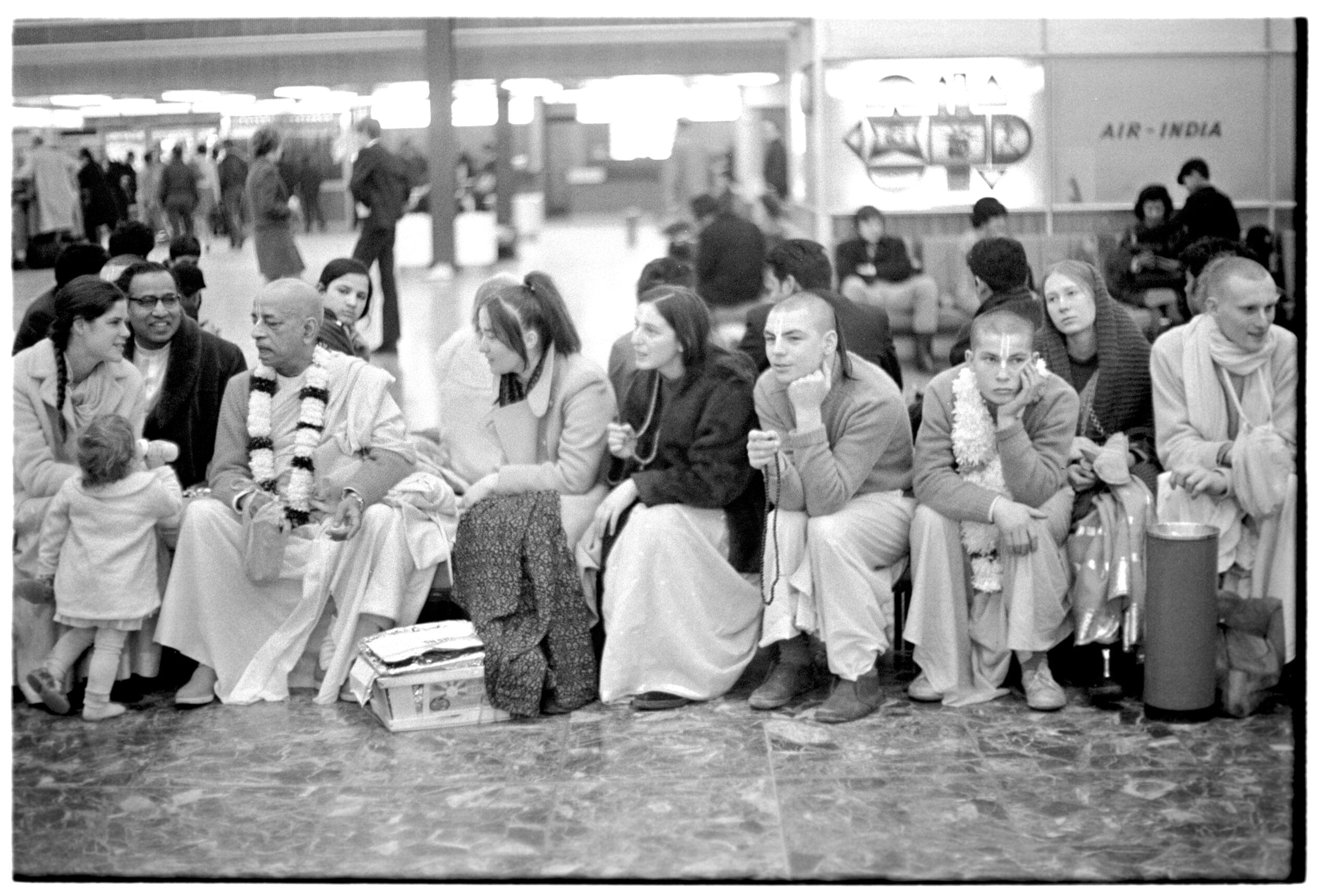 Malati, Baby Saraswati, Swami Prabhupad, devotees and Shyamasundar Das ( R) awaiting in airport.