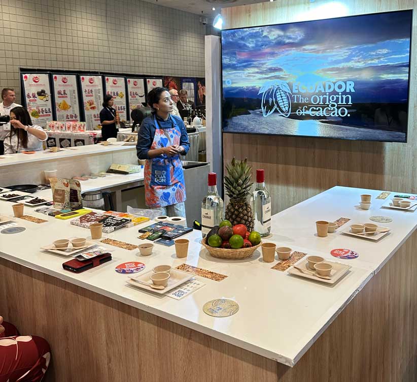 Woman looking at a screen in front of tables of chocolate tasting 