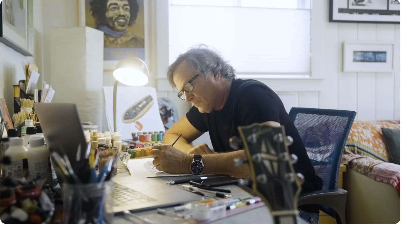 man painting at desk