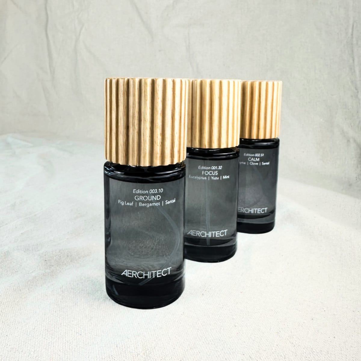 set of three fragrance bottles with green labels and gold tops