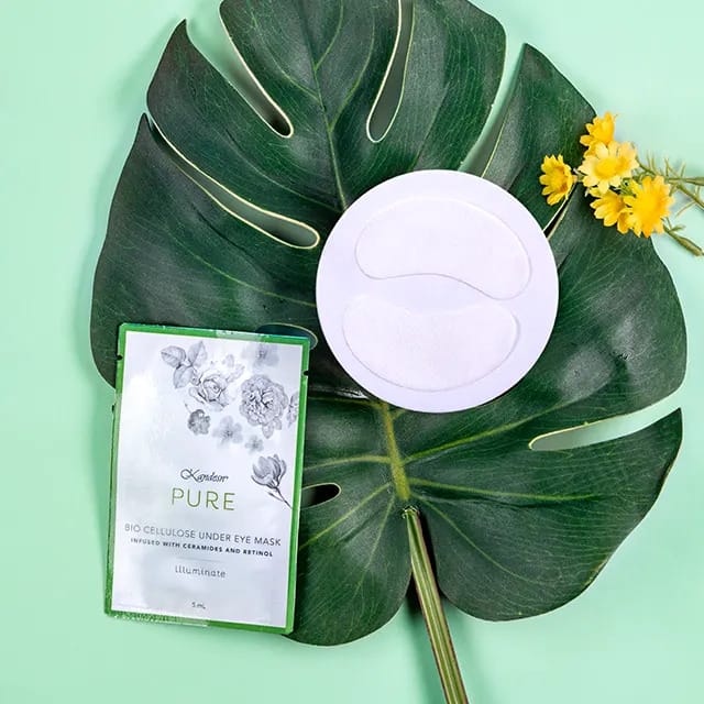 under eye mask set on top of large green leaf