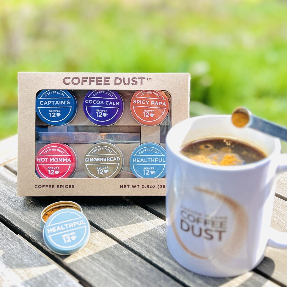 image of containers of Vashon Island Coffee Dust and coffee cup on picnic table